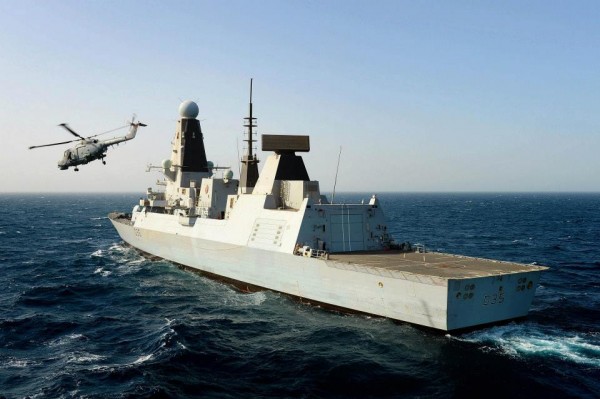 Lynx helicopters flies past HMS Dragon.