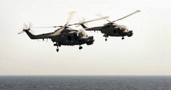 two Lynx aircraft fly side by side off HMS Dragon