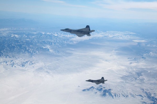 Two F-22 Raptors assigned to the 95th Fighter Squadron, Tyndall Air Force Base, Fla., fly over the Nevada Test and Training Range Feb. 4, 2016, during an Exercise Red Flag 16-1 training sortie. The range is the largest contiguous air and ground space available for peace time military operations in the free world, offering 5,000 square miles of air space and more than 1,200 targets and threat simulators. (U.S. Air Force photo by Master Sgt. Burt Traynor/Released)