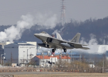 One of four U.S. F-22 stealth fighters prepares to land at Osan Air Base in Pyeongtaek, South Korea, Wednesday, Feb. 17, 2016. Four U.S. F-22 stealth fighters flew over South Korea on Wednesday in a clear show of power against North Korea, a day after South Korea's president warned of the North's collapse amid a festering standoff over its nuclear and missile ambitions. (AP Photo/Lee Jin-man)