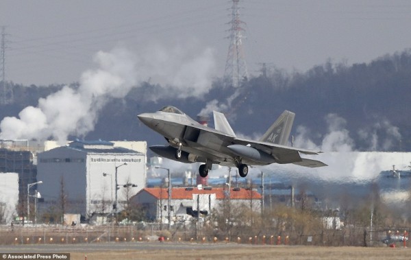 One of four U.S. F-22 stealth fighters prepares to land at Osan Air Base in Pyeongtaek, South Korea, Wednesday, Feb. 17, 2016. Four U.S. F-22 stealth fighters flew over South Korea on Wednesday in a clear show of power against North Korea, a day after South Korea's president warned of the North's collapse amid a festering standoff over its nuclear and missile ambitions. (AP Photo/Lee Jin-man)