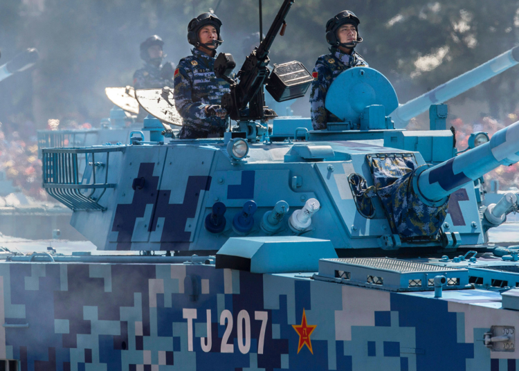 BEIJING, CHINA - SEPTEMBER 03:  Chinese soldiers ride in tanks as they pass in front of Tiananmen Square and the Forbidden City during a military parade on September 3, 2015 in Beijing, China. China is marking the 70th anniversary of the end of World War II and its role in defeating Japan with a new national holiday and a military parade in Beijing.  (Photo by Kevin Frayer/Getty Images)